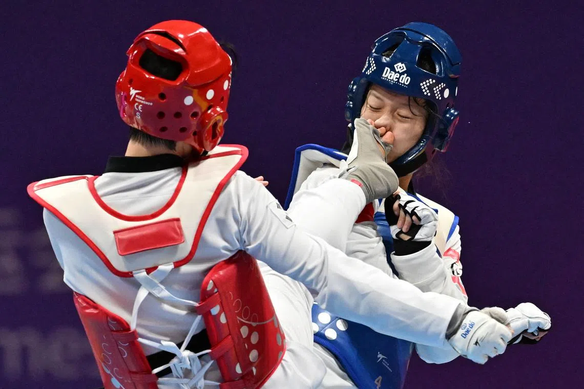 China's Zhou Zeqi (blue) competing with South Korea's Lee Da-bin at the Taekwondo women's +67kg final event during the Hangzhou 2022 Asian Games in Hangzhou, China on Sept 28.