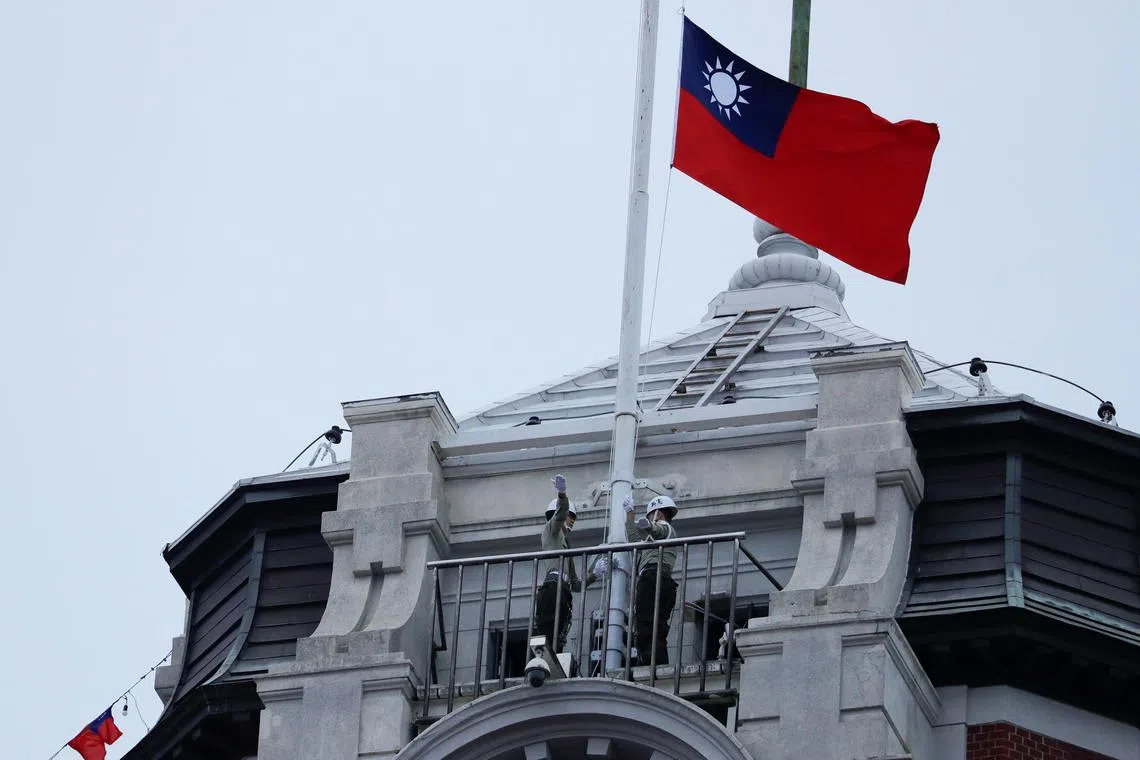 FILE PHOTO: Honor guards raise a Taiwanese flag at the Presidential Palace ahead of the National Day celebration ceremony in Taipei, Taiwan October 10, 2023. REUTERS/Carlos Garcia Rawlins/File Photo