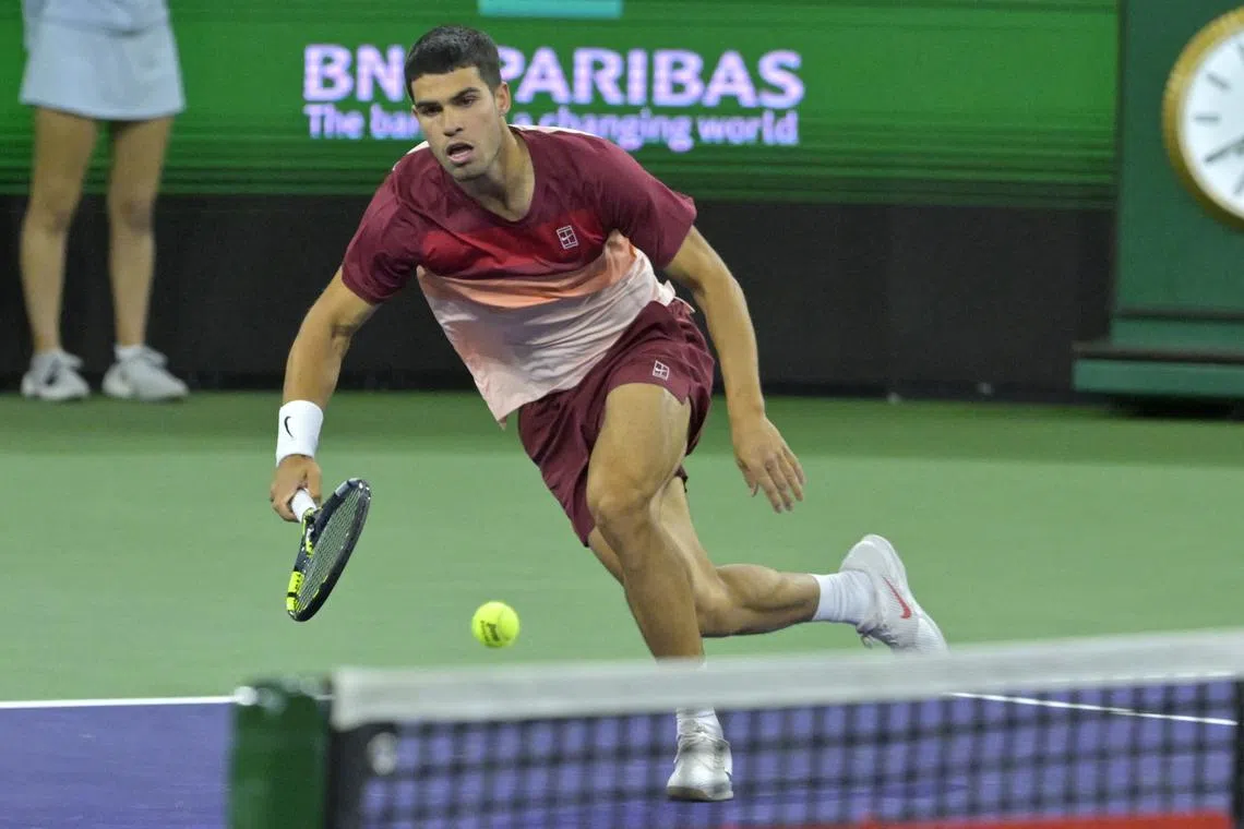 FILE PHOTO: Mar 13, 2025; Indian Wells, CA, USA; Carlos Alcaraz (ESP) hits a shot as he defeated Francisco Cerundolo (not pictured) in the quarterfinal of the BNP Paribas Open at the Indian Well Tennis Garden. Mandatory Credit: Jayne Kamin-Oncea-Imagn Images/File Photo