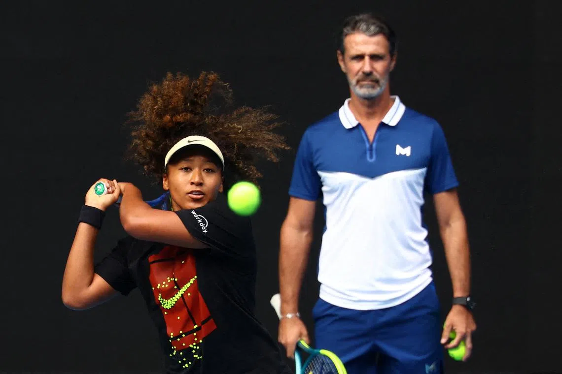 FILE PHOTO: Tennis - Australian Open - Practice - Melbourne Park, Melbourne, Australia - January 9, 2025 Japan's Naomi Osaka during a practice session as coach Patrick Mouratoglou looks on ahead of the Australian Open REUTERS/Edgar Su/File Photo