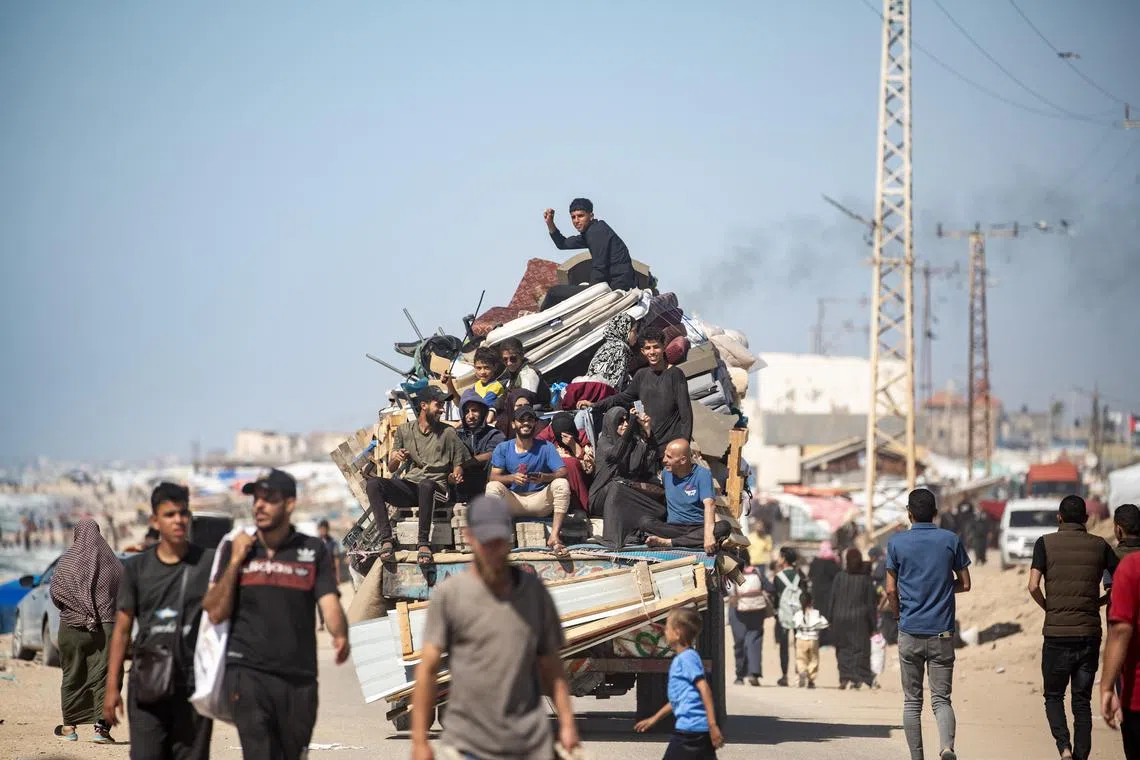 Internally displaced Palestinians leave with their belongings following an evacuation order issued by the Israeli army, in Rafah, southern Gaza Strip, on May 8, 2024. 