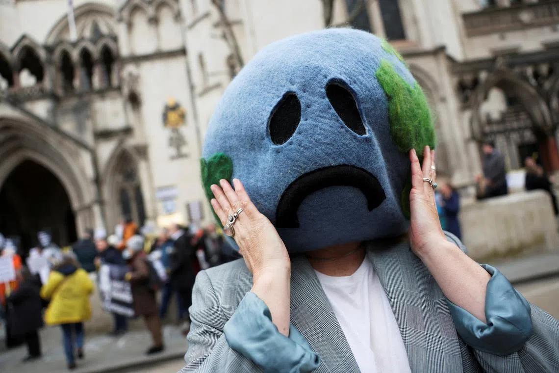 FILE PHOTO: A climate activist demonstrates outside the high court in London, Britain, February 20, 2024. REUTERS/Isabel Infantes/File Photo