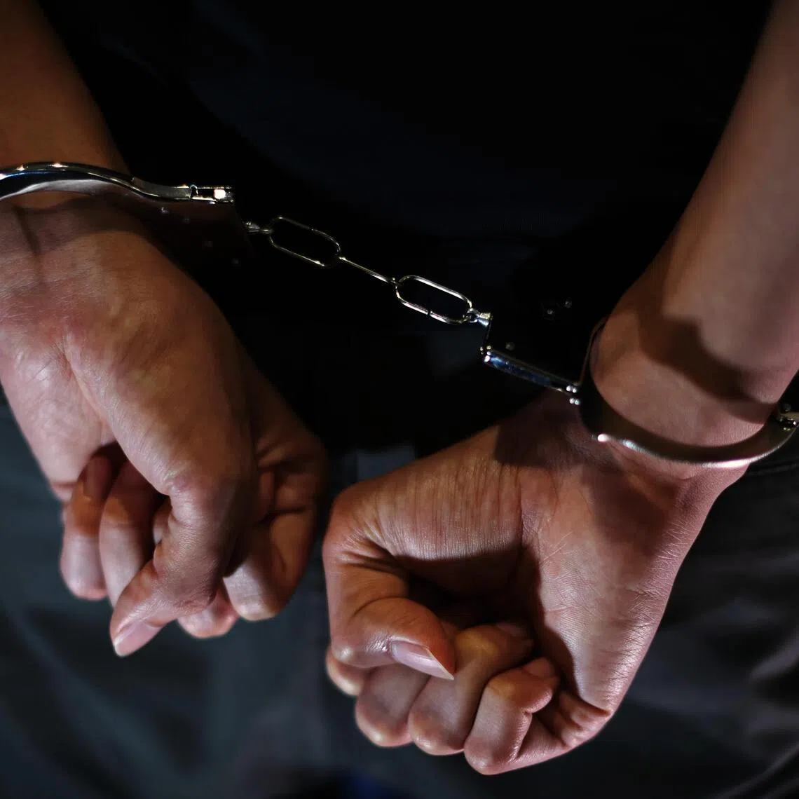CMG20240419-HengYY01 / 王彦燕 / 被捕示意图 Arrested - Handcuffs stock photo [ SPH] tags: crime、state courts、Underage、法庭、初庭、男子被捕、Handcuffed person、Criminal man hands locked in handcuffs. Arrested man handcuffed hands at the back. Prisoner or arrested terrorist, close-up of hands in handcuff.