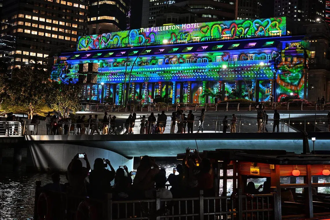 Media preview of Brightening Lives, a light projection show at The Fullerton Hotel Singapore on Dec 19, 2024. It is part of the programme for this year?s Marina Bay Singapore Countdown (MBSC) 2025. The projections feature three original artworks by artists from ART:DIS, a non-profit organisation that empowers artists with disabilities. With the theme ?Thriving?, the projections on the facade of The Fullerton Hotel Singapore hope to encourage the community to reflect on what it means to thrive in Singapore, and collectively tell a story of tenacity, resilience and progress.