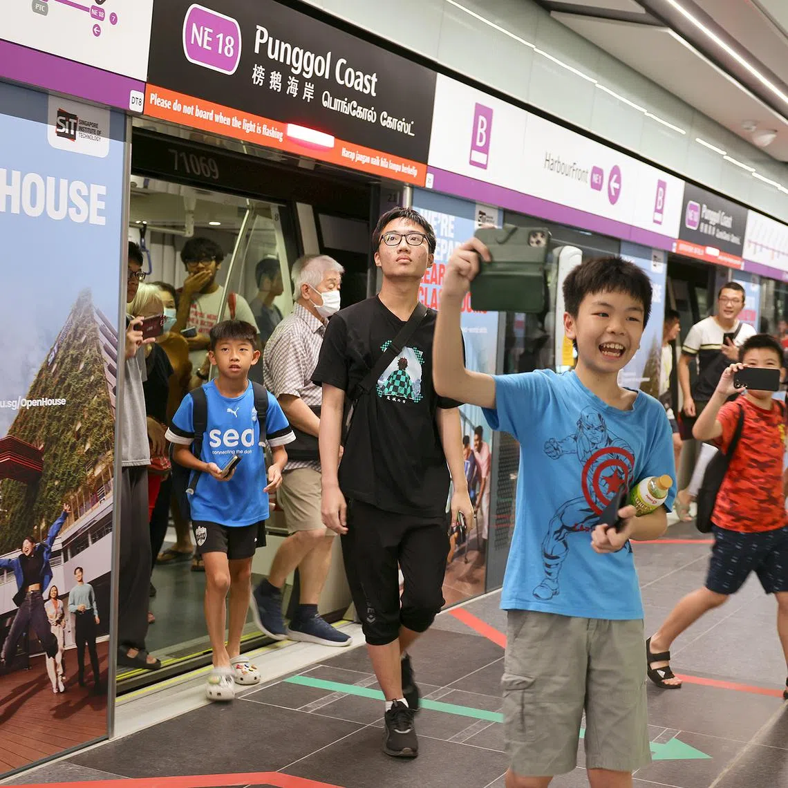The first passengers arriving at the new Punggol Coast MRT station on Dec 10.