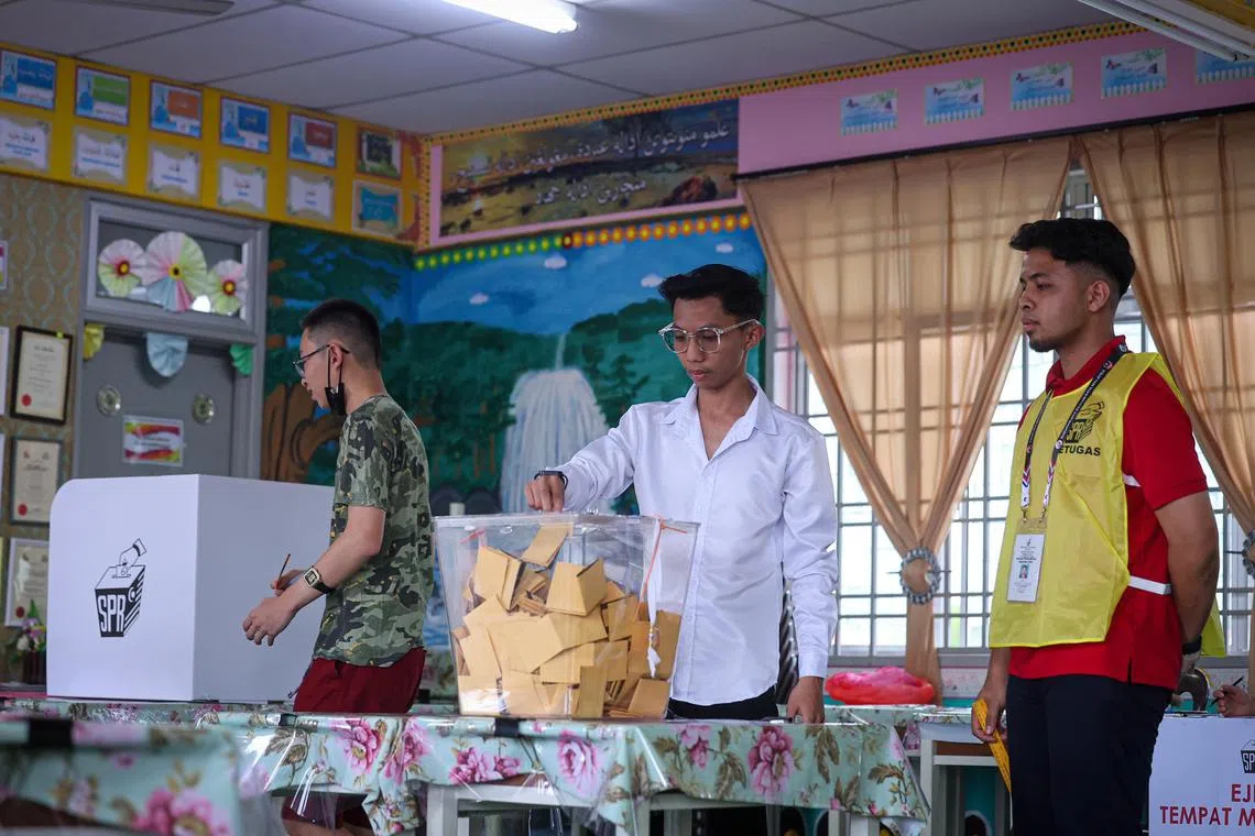 MUAR, JOHOR - A voter casting his ballot at a school in the Simpang Jeram state ward by-election on Saturday (Sept 9, 2023).