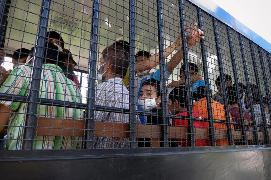 FILE PHOTO: Suspected Uyghurs are transported back to a detention facility in the town of Songkhla in southern Thailand after visiting women and children at a separate shelter March 26, 2014. Picture taken March 26, 2014. REUTERS/Andrew RC Marshall/File Photo