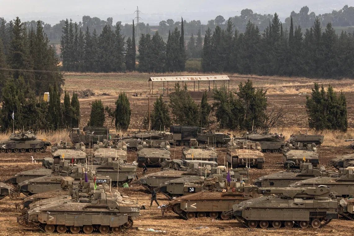 Israeli military vehicles in a staging area near Kiryat Shmona, Israel, near the border with Lebanon, on Oct 1.