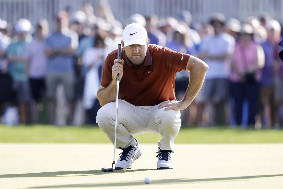 Scottie Scheffler, of the US, lines up putts on the 10th hole during the first round of the PGA Championship.