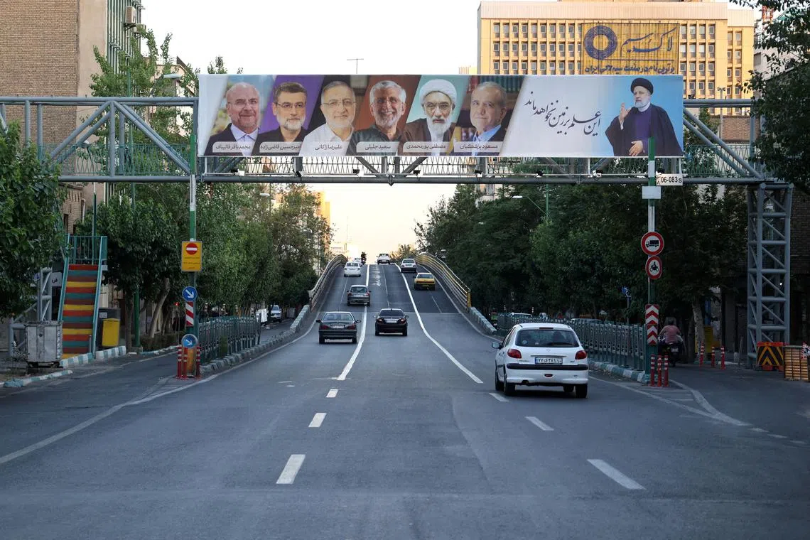 FILE PHOTO: A billboard with a picture of the late President Ebrahim Raisi and the presidential candidates is displayed on a street in Tehran, Iran, June 17, 2024. Majid Asgaripour/WANA (West Asia News Agency) via REUTERS/File Photo