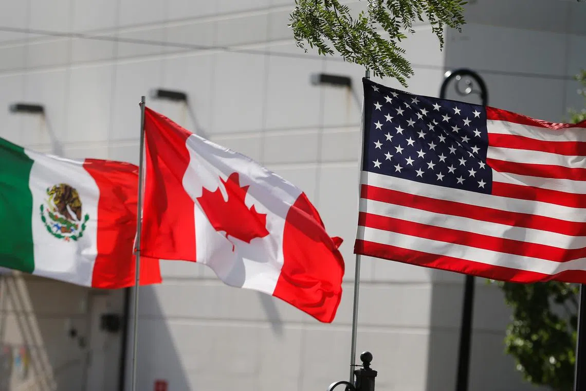 FILE PHOTO: Flags of the U.S., Canada and Mexico fly next to each other in Detroit, Michigan, U.S. August 29, 2018.  REUTERS/Rebecca Cook/File Photo