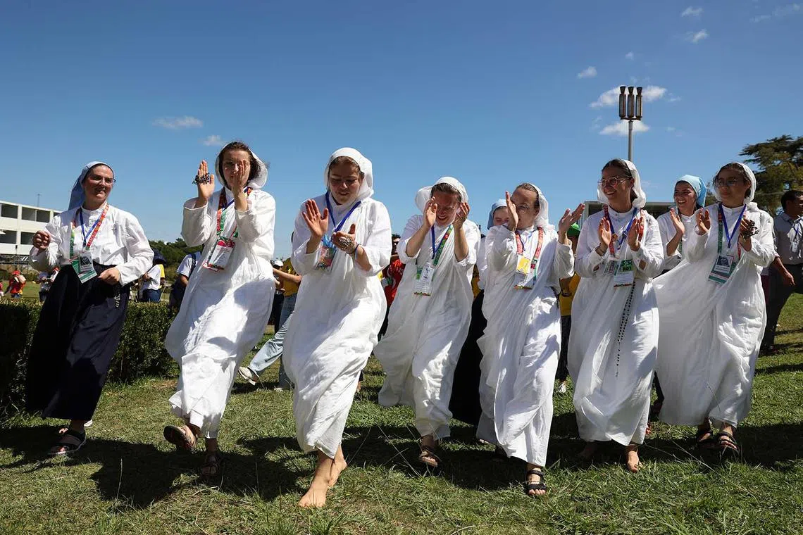 Pilgrims sing and dance on the first day of the World Youth Day in Lisbon, Portugal, Aug 1, 2023. 