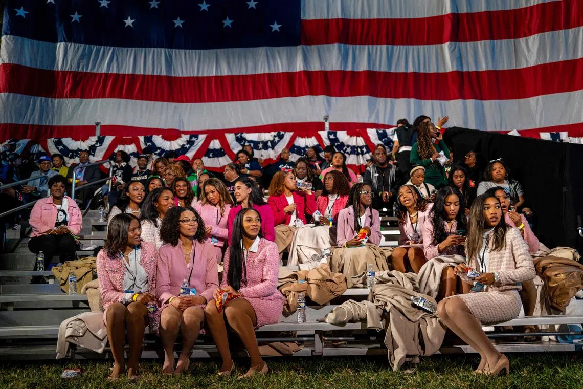 Women sitting together ahead of an election night event held by Democratic presidential nominee, US Vice President Kamala Harris at Howard University on Nov 5, 2024 in Washington, DC. 