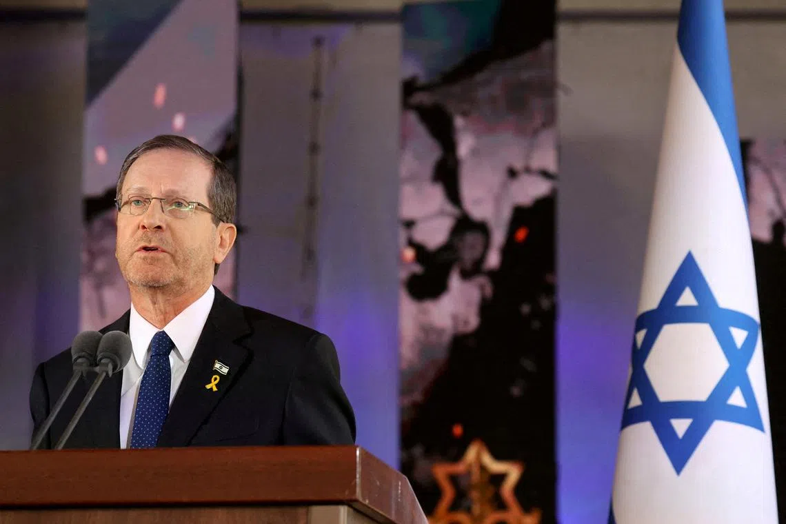FILE PHOTO: Israel's President Isaac Herzog delivers a speech during a memorial ceremony of the Hamas attack on October 7 last year that sparked the ongoing war in Gaza, at the Mount Herzl military cemetery in Jerusalem on October 27, 2024. GIL COHEN-MAGEN/Pool via REUTERS/File Photo