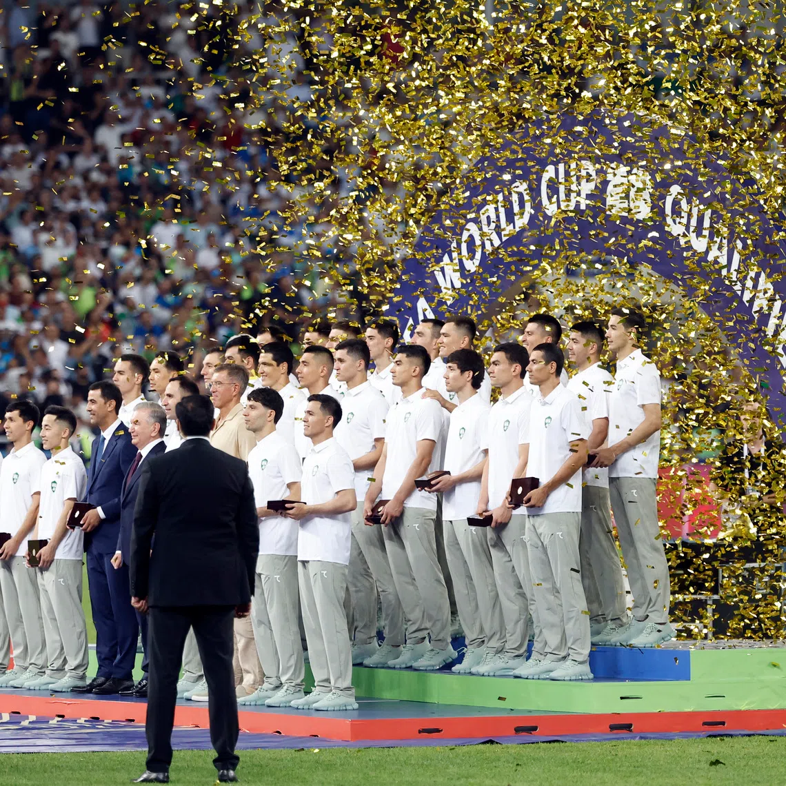 Soccer Football - World Cup - AFC Qualifiers - Group A - Uzbekistan v Qatar - Milliy Stadium, Tashkent, Uzbekistan - June 10, 2025 Uzbekistan President Shavkat Mirziyoyev and players pose for a picture to celebrate securing a spot at the 2026 FIFA World Cup