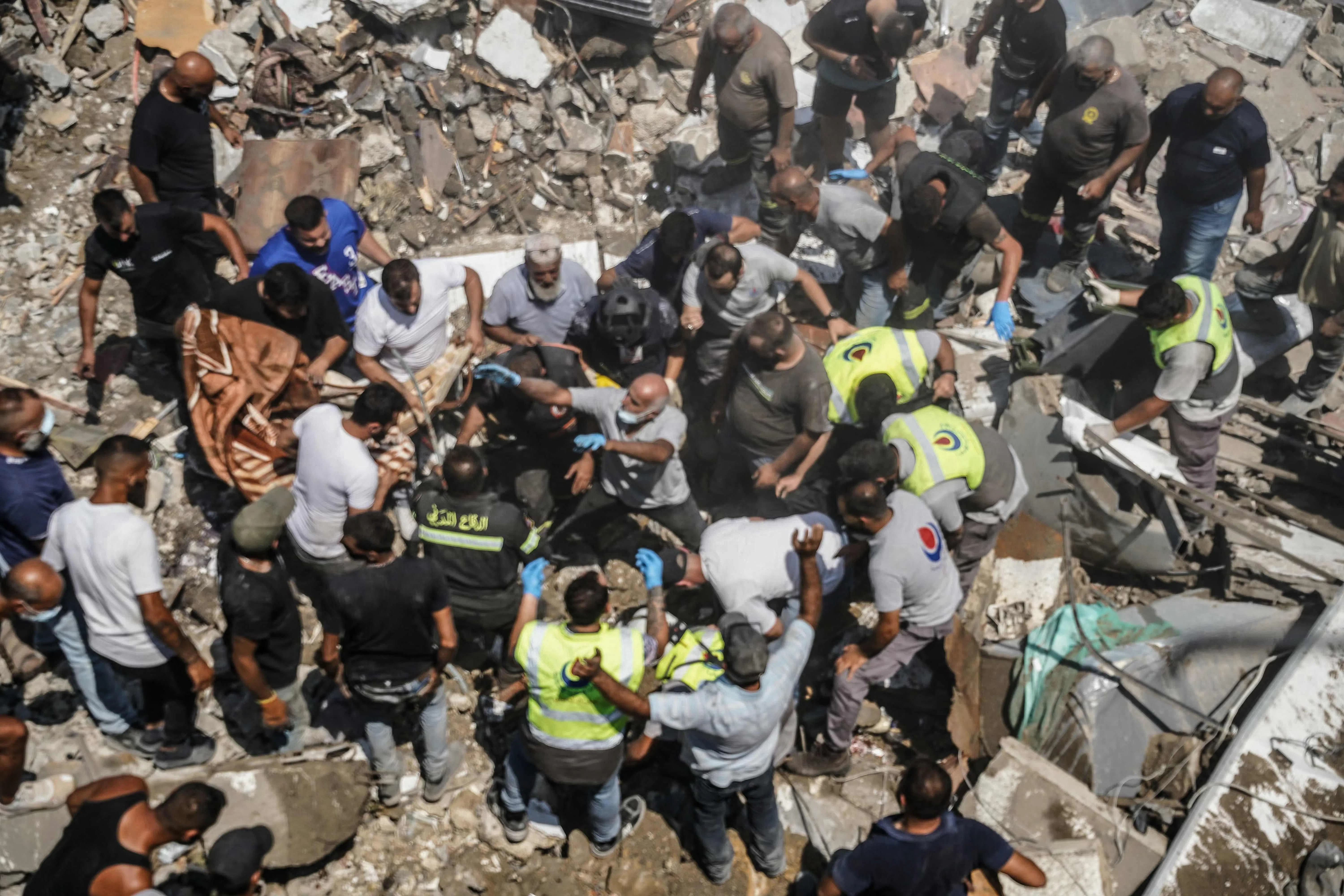 First responders and residents searching the site of an Israeli airstrike that targeted the southern Lebanese town of Deir al-Zahrani on Aug 15.