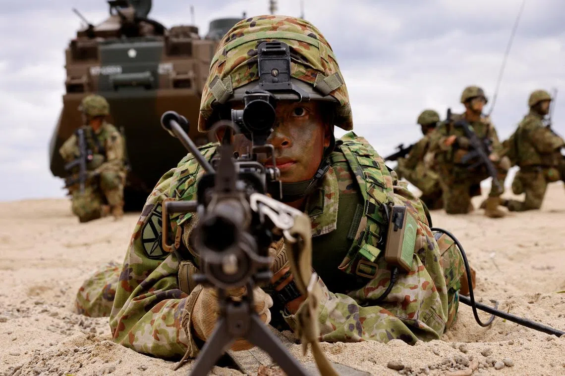 FILE PHOTO: Japanese Ground Self-Defense Force's Amphibious Rapid Deployment Brigade (ARDB) soldiers take part in a marine landing drill as a part of the country's nationwide 05JX military exercises at Tokunoshima island, Kagoshima prefecture, southwestern Japan November 19, 2023.  REUTERS/Issei Kato/File Photo