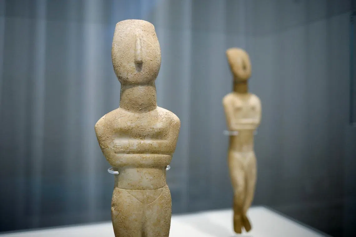 Marble Cycladic female figurines are displayed during the opening of the exhibition ''Homecoming. Cycladic treasures on their return journey'' at Museum of Cycladic Art, in Athens Greece, November 2, 2022. 