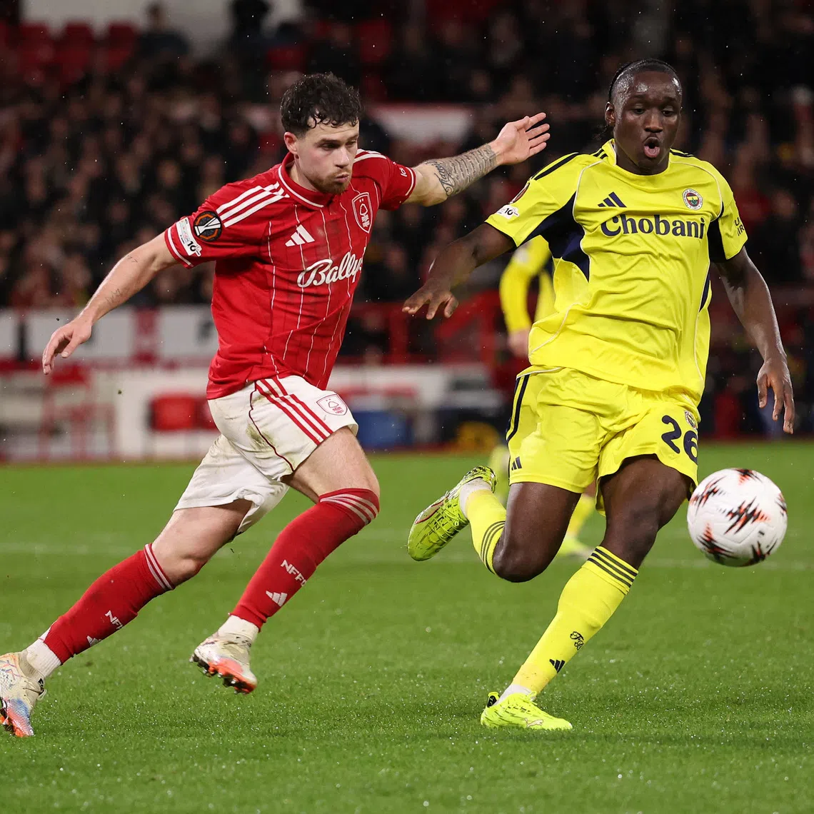 Soccer Football - UEFA Europa League - Play Off - Second Leg - Nottingham Forest v Fenerbahce - The City Ground, Nottingham, Britain - February 26, 2026 Nottingham Forest's Neco Williams in action with Fenerbahce's Sidiki Cherif REUTERS/Chris Radburn