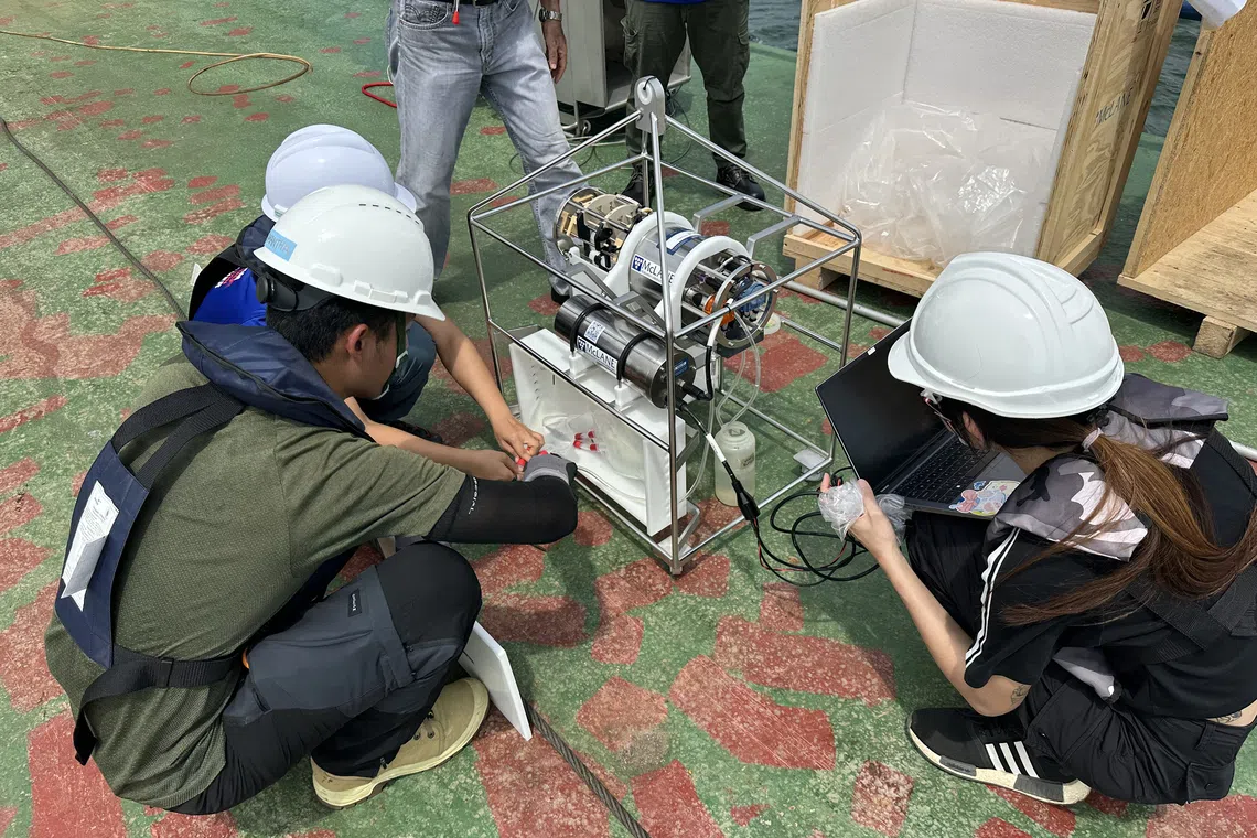 NUS researchers testing out a special system of “traps within a trap” for the expedition.