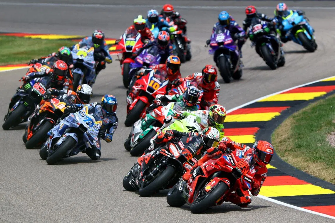 FILE PHOTO: MotoGP - German Grand Prix - Sachsenring, Hohenstein-Ernstthal, Germany - July 13, 2025 Ducati Lenovo Team's Marc Marquez, BK8 Gresini Racing MotoGP's Alex Marquez and Aprilia Racing's Marco Bezzecchi in action with riders during the race REUTERS/Lisi Niesner/File Photo
