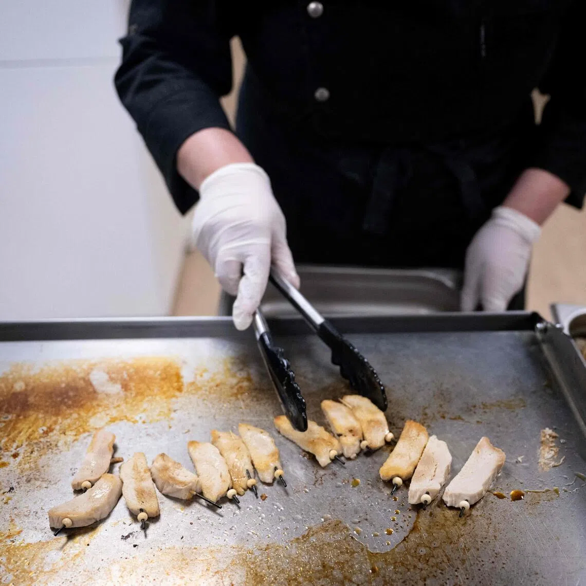 A chef cooks a plant-based meat substitute at a factory in Duppigheim, eastern France, on March 18, 2024. 