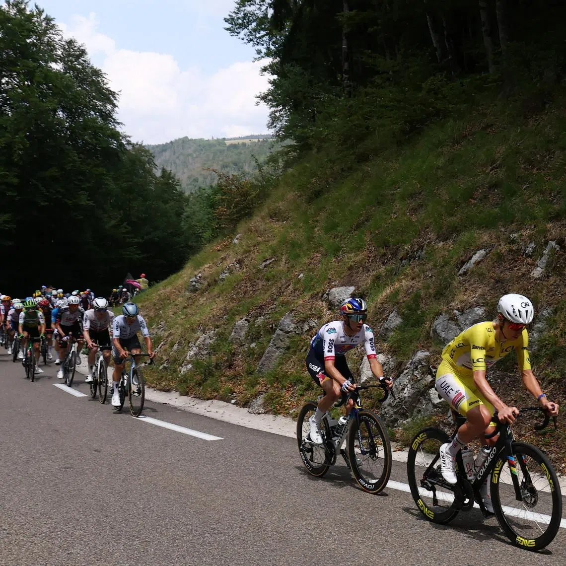 Cycling - Tour de France - Stage 15 - Champagnole to Plateau de Solaison - Champagnole, France - July 19, 2026 UAE Team Emirates - XRG's Tadej Pogacar wearing the yellow jersey in action with other cyclists during stage 15 REUTERS/Gonzalo Fuentes