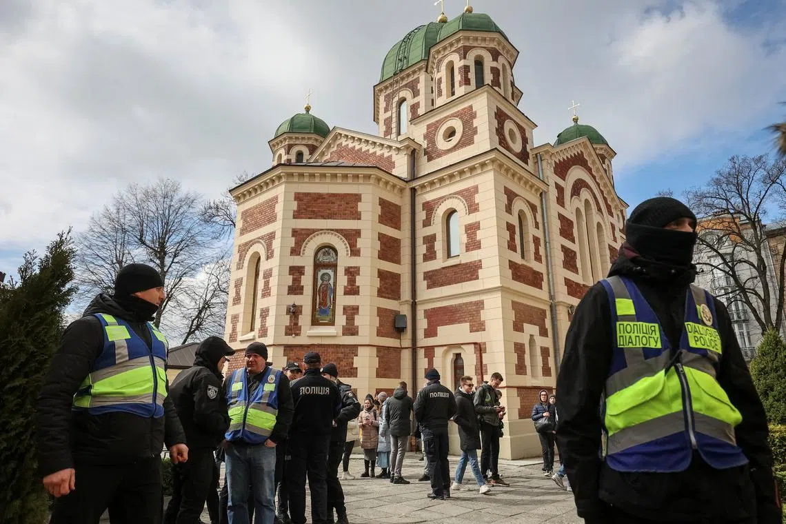 FILE PHOTO: Ukrainian police officers stand next to St. George's Cathedral of the Ukrainian Orthodox Church, accused of being linked to Moscow, amid Russia's attack on Ukraine, in Lviv, Ukraine April 5, 2023. REUTERS/Roman Baluk/File Photo
