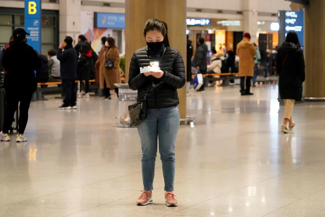 FILE PHOTO: A woman checks her ticket on her cellphone at Incheon International Airport in Incheon, South Korea, January 3, 2020.    REUTERS/Kim Hong-Ji/File Photo