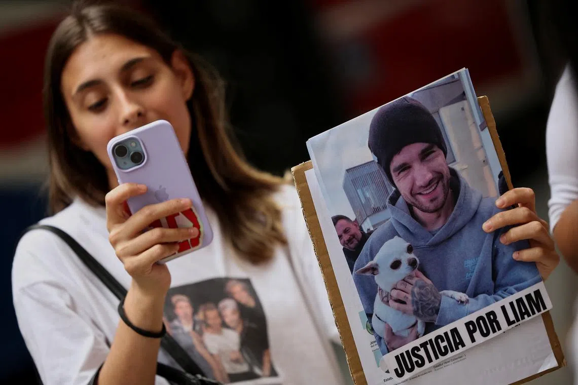 FILE PHOTO: A fan of former One Direction band member Liam Payne holds an image of Payne that reads \"Justice for Liam\" as she protests outside court in demand of justice after Payne's death, in Buenos Aires, Argentina, February 14, 2025. REUTERS/Agustin Marcarian/File Photo