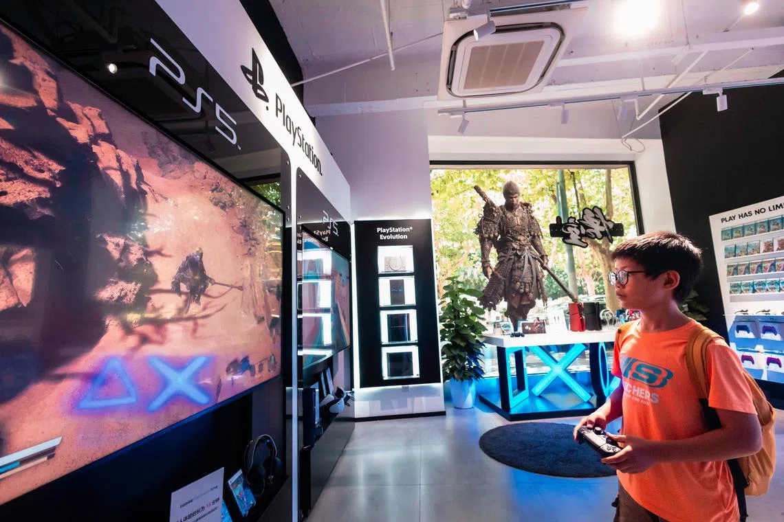 A boy plays the video game 'Black Myth: Wukong' in a Sony store in Shanghai on Aug 26.