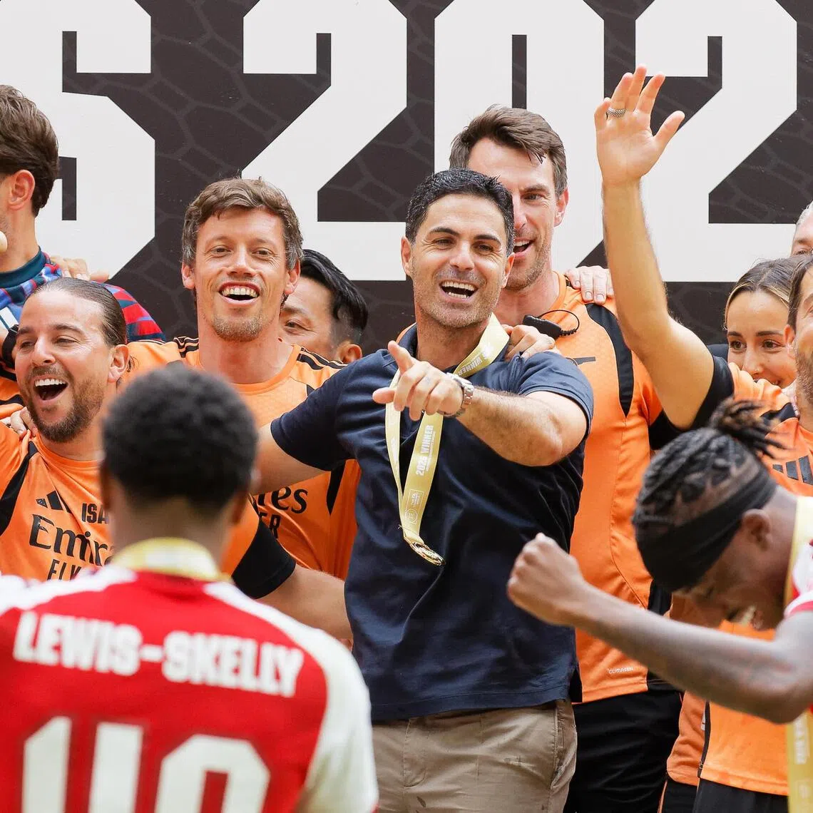 Arsenal manager Mikel Arteta (centre) celebrating with players and staff after beating Manchester City 3-0, at the Millennium Stadium in Cardiff on Aug 16.