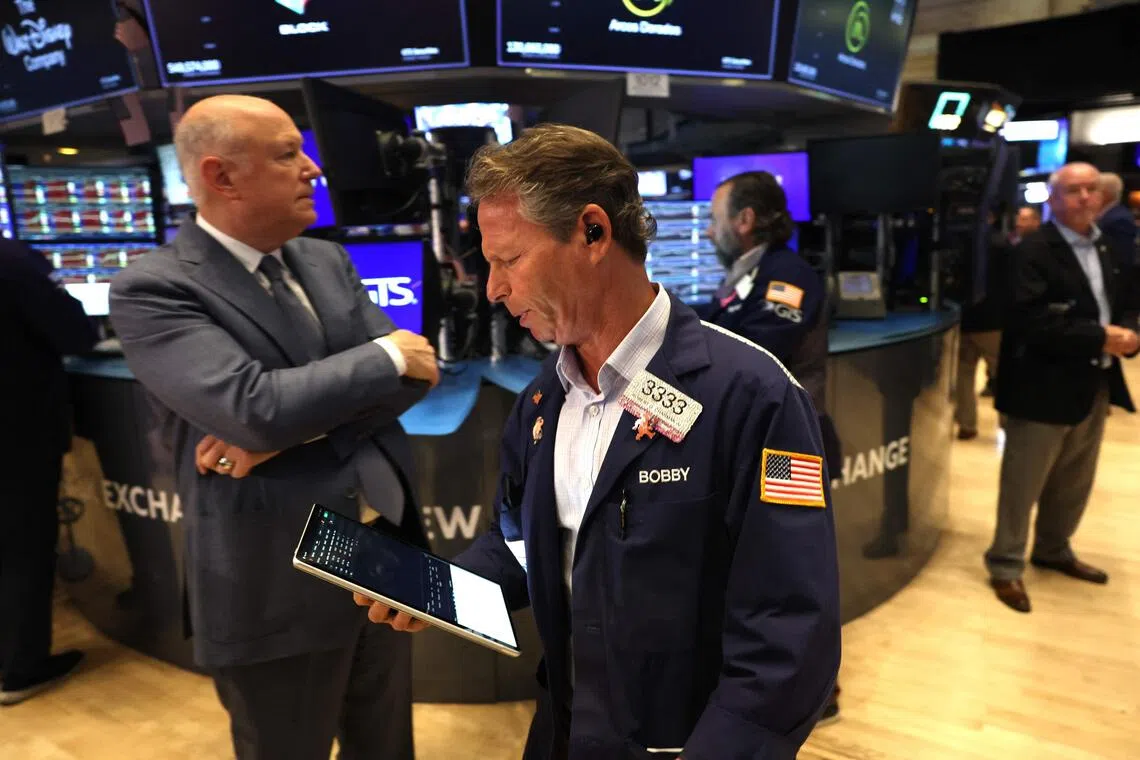 Traders work on the floor of the New York Stock Exchange in New York.