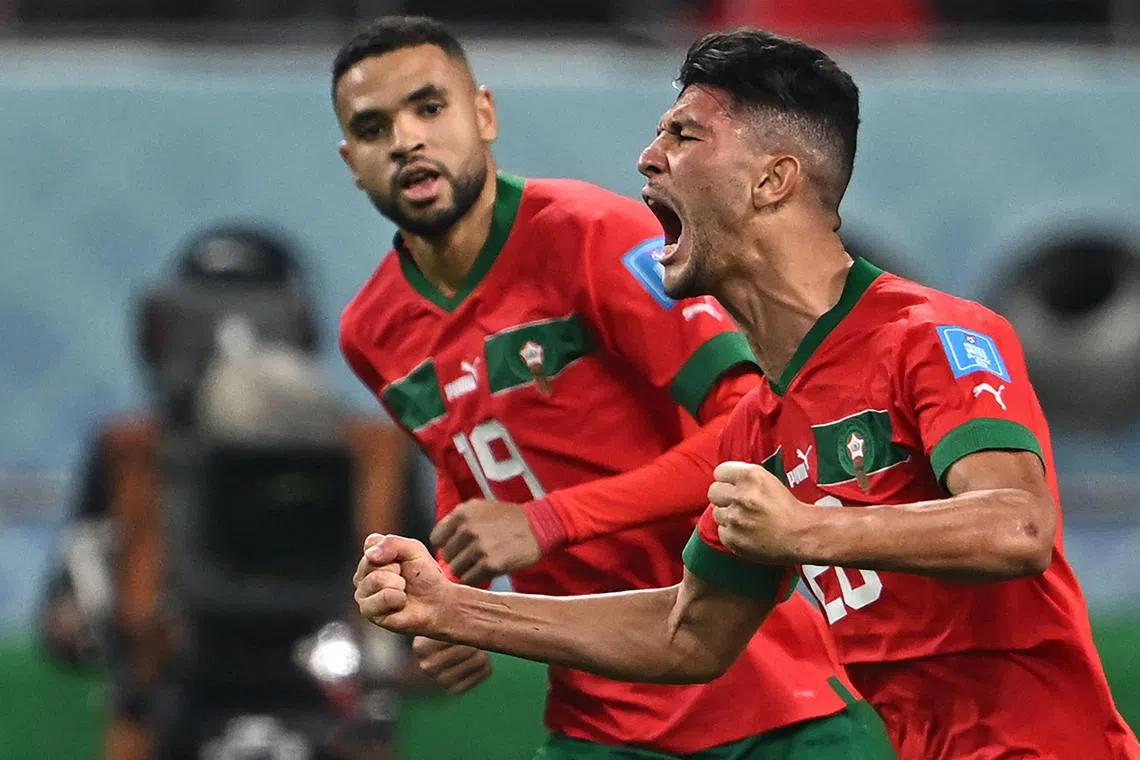 Moroccan player Achraf Dari (right) celebrates a goal during the Qatar 2022 World Cup tournament.