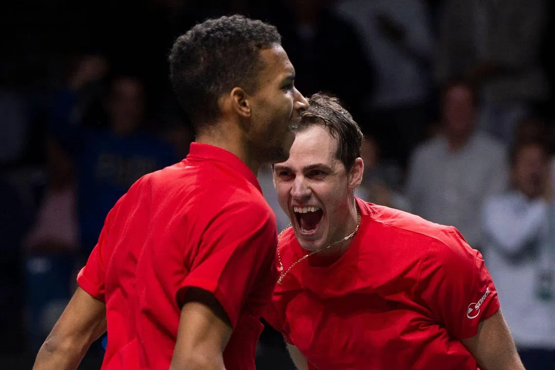 Canada’s Felix Auger-Aliassime (left) and Vasek Pospisil celebrate after winning the men's doubles semi-final.