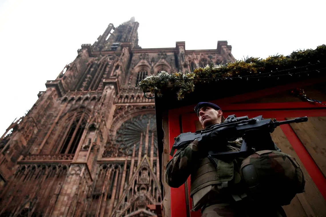 FILE PHOTO: A French soldier stands guard near a closed wooden shop at the traditional Christkindelsmaerik (Christ Child market) in front of the Cathedral the day after a shooting in Strasbourg, France, December 12, 2018.   REUTERS/Christian Hartmann/File Photo