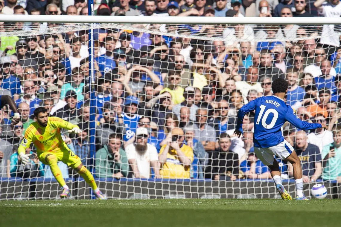 Iliman Ndiaye of Everton scoring the equaliser from the penalty spot past Arsenal's David Raya in a 1-1 English Premier League draw at Goodison Park on April 5.