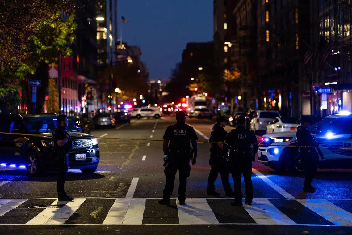 Members of various law enforcement agencies are at the scene where two members of the National Guard were shot in Washington on Nov 26.