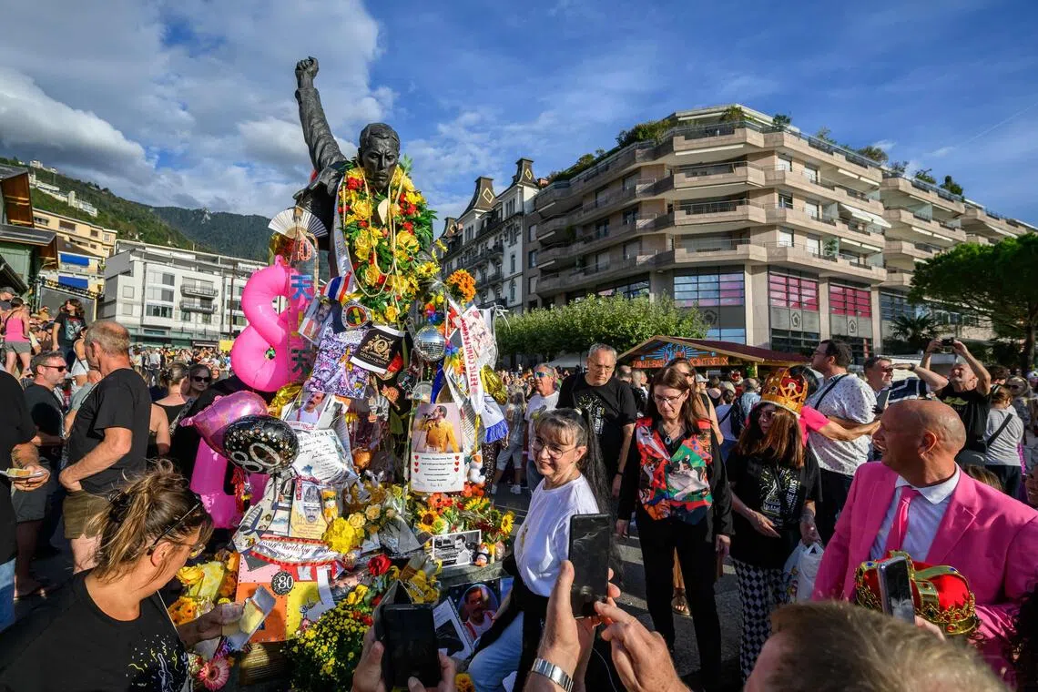 Fans gather around the iconic Freddie Mercury statue overlooking Lake Geneva during Montreux Freddie Day on Sept 5 in Montreux, Switzerland.
