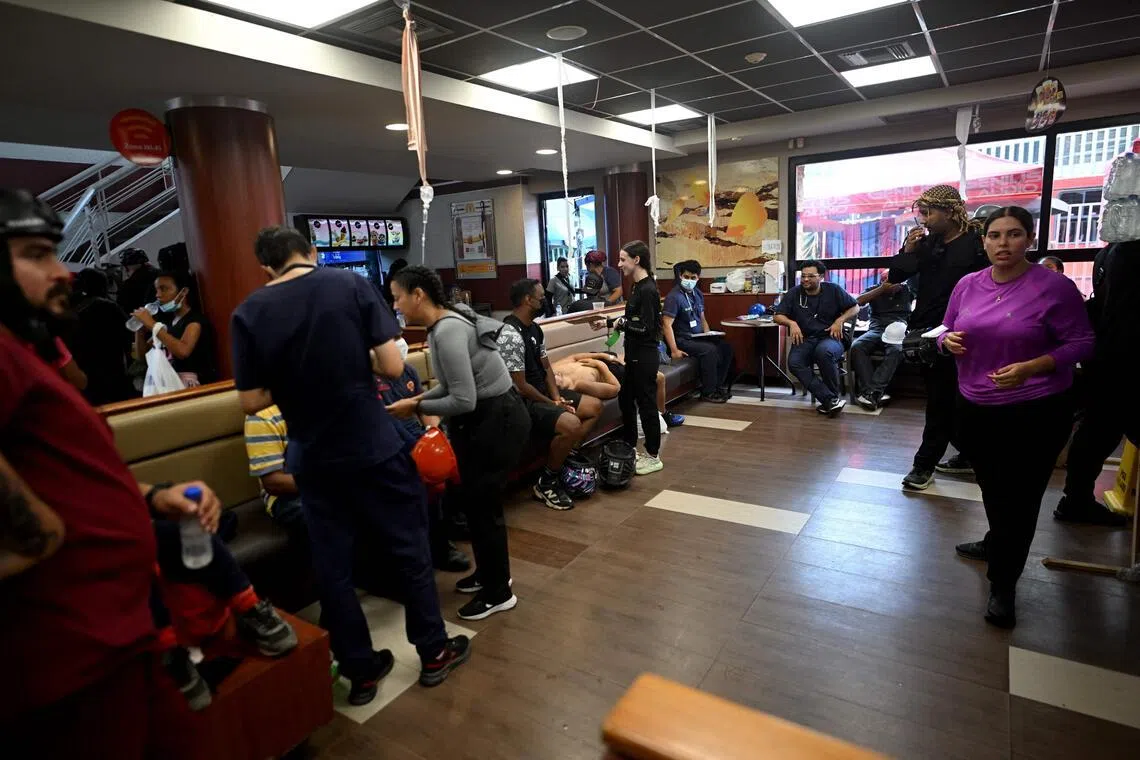 Health workers tend to people inside a McDonald’s restaurant operating as a medical care center following twin earthquakes in Caraballeda, Venezuela, on July 3.