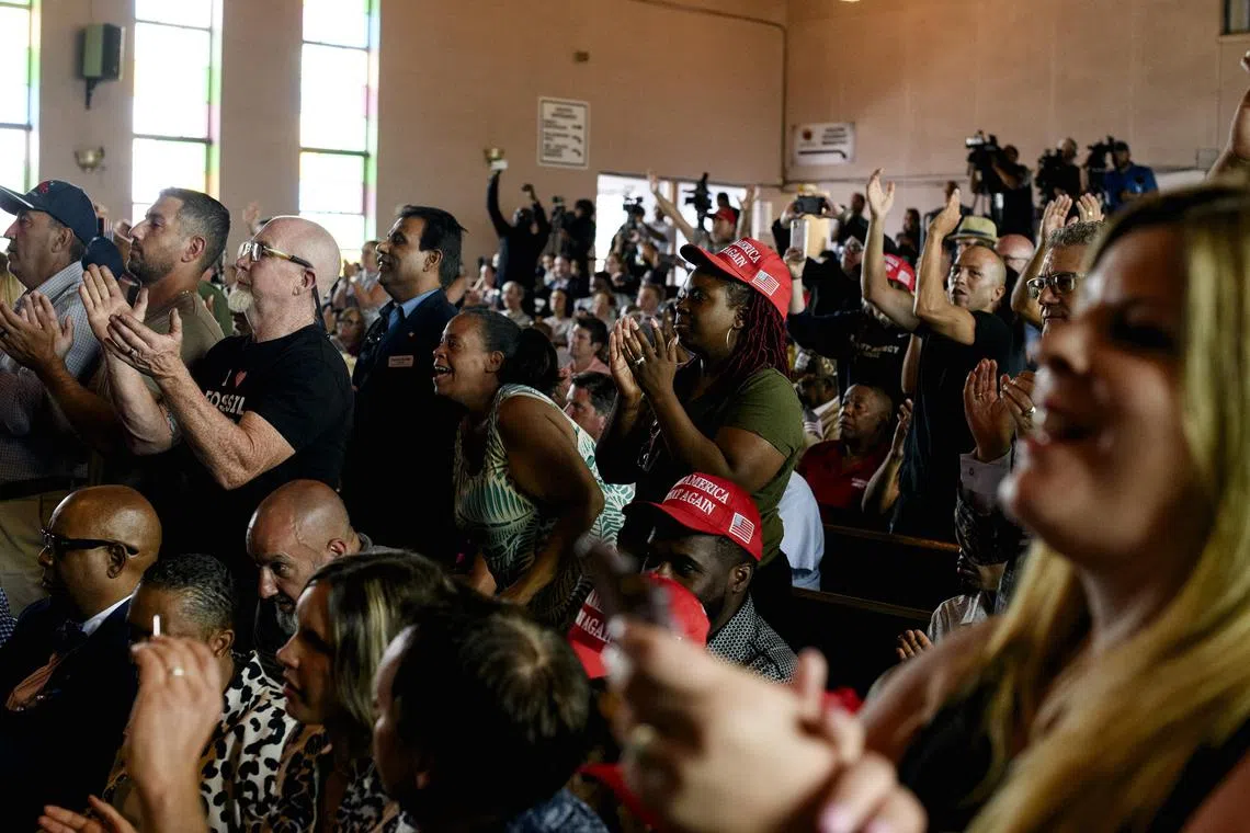 Attendees cheer as Former President Donald Trump speaks at a round table event at 180 Church in Detroit on Saturday, June 15, 2024. Former President Donald J. Trump, courting Black voters at a church on the west side of Detroit on Saturday, sought to harness animus toward migrants crossing the border, sanitized his track record on race and sold himself as the best president for Black Americans since Abraham Lincoln. (Brittany Greeson/The New York Times)