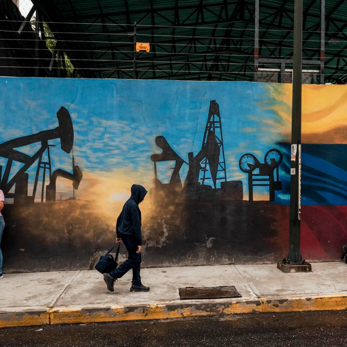 People outside the state oil company Petróleos de Venezuela’s headquarters in Caracas, on Oct 8, 2025.