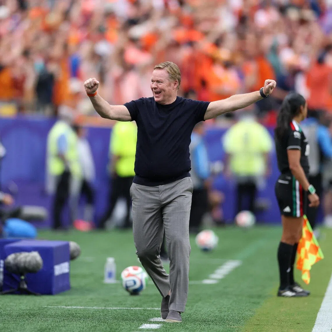 Netherlands coach Ronald Koeman (right) celebrating after their second goal in the 3-1 World Cup win over Tunisia on June 25.