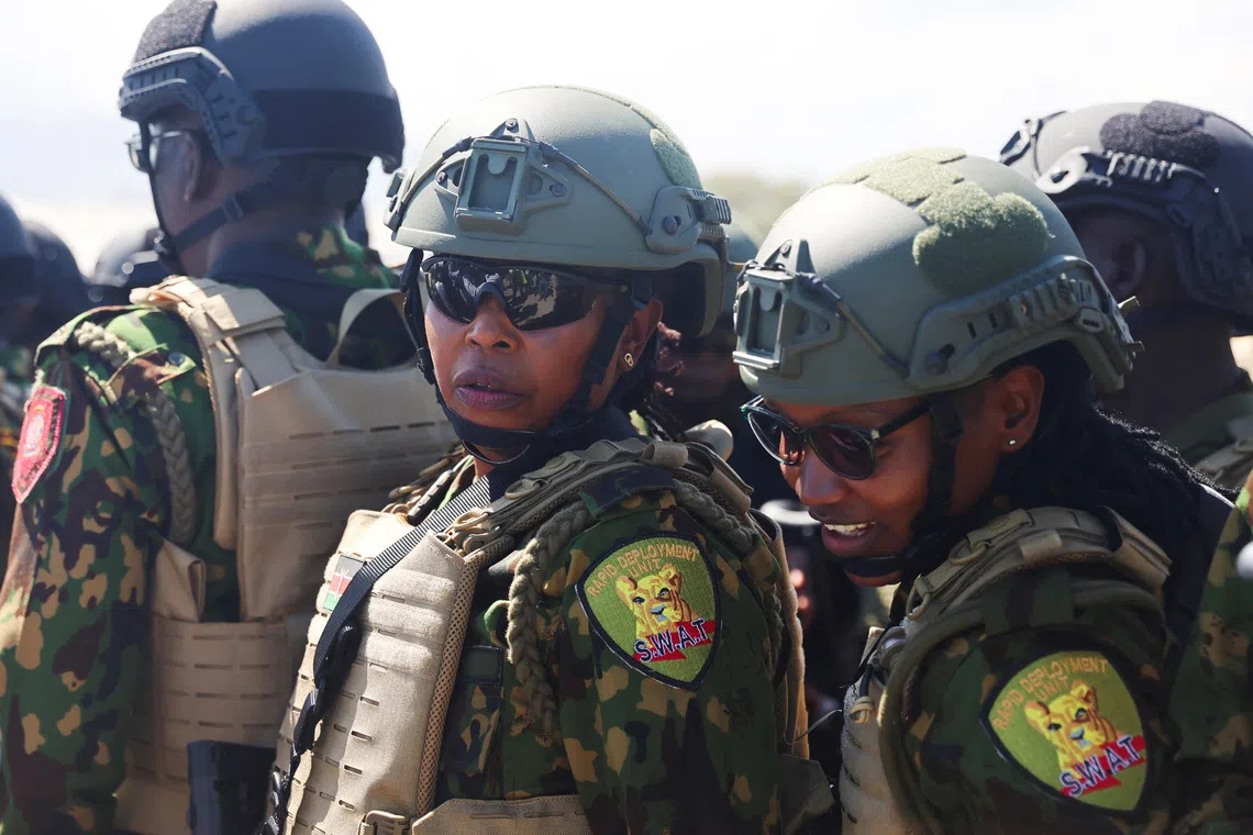 Kenyan police officers share a moment after landing to reinforce a security mission to tackle violence in Haiti, in Port-au-Prince, Haiti February 6, 2025. REUTERS/Ralph Tedy Erol