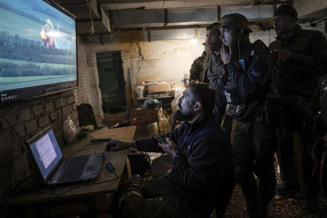 A drone operator shares footage of an attack against a Russian position with fellow soldiers of the Ukrainian army’s Carpathian Sich Battalion at an underground base in the Kharkiv region of Ukraine on May 11, 2022. 