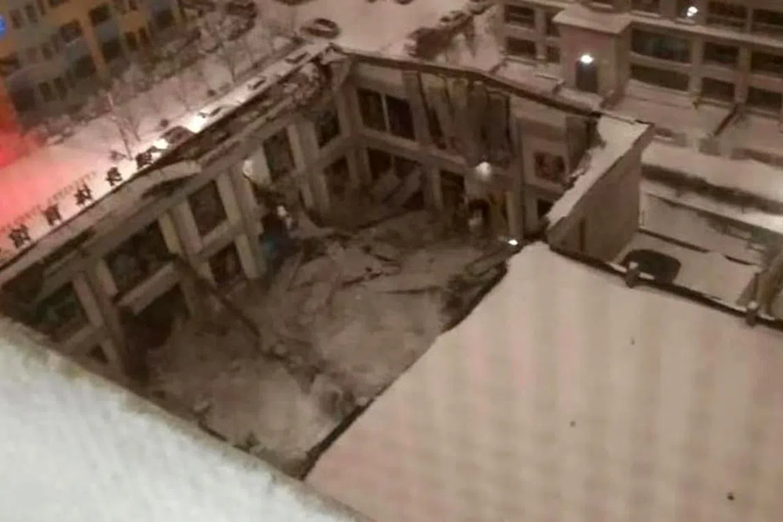 A screen grab from a security camera shows the collapsed roof of a gym in Jiamusi city, Heilongjiang province, China.