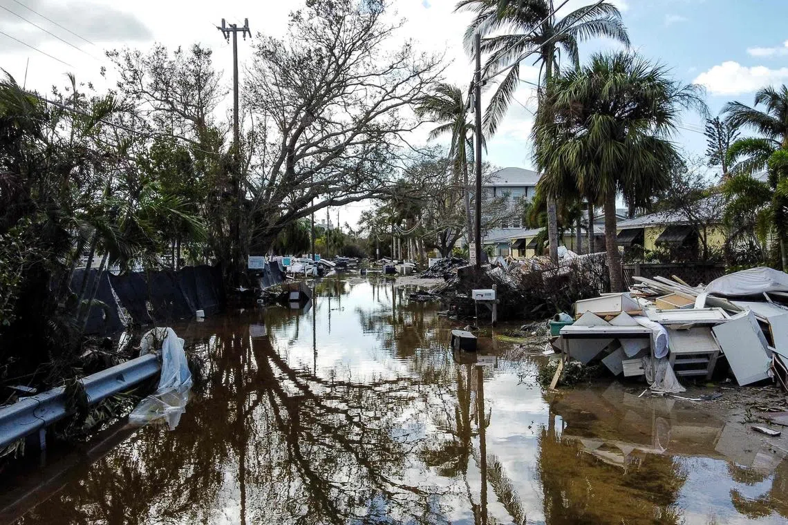 A flooded street with debris in the aftermath of Hurricane Milton, in Siesta Key, Florida, on Oct 10.
