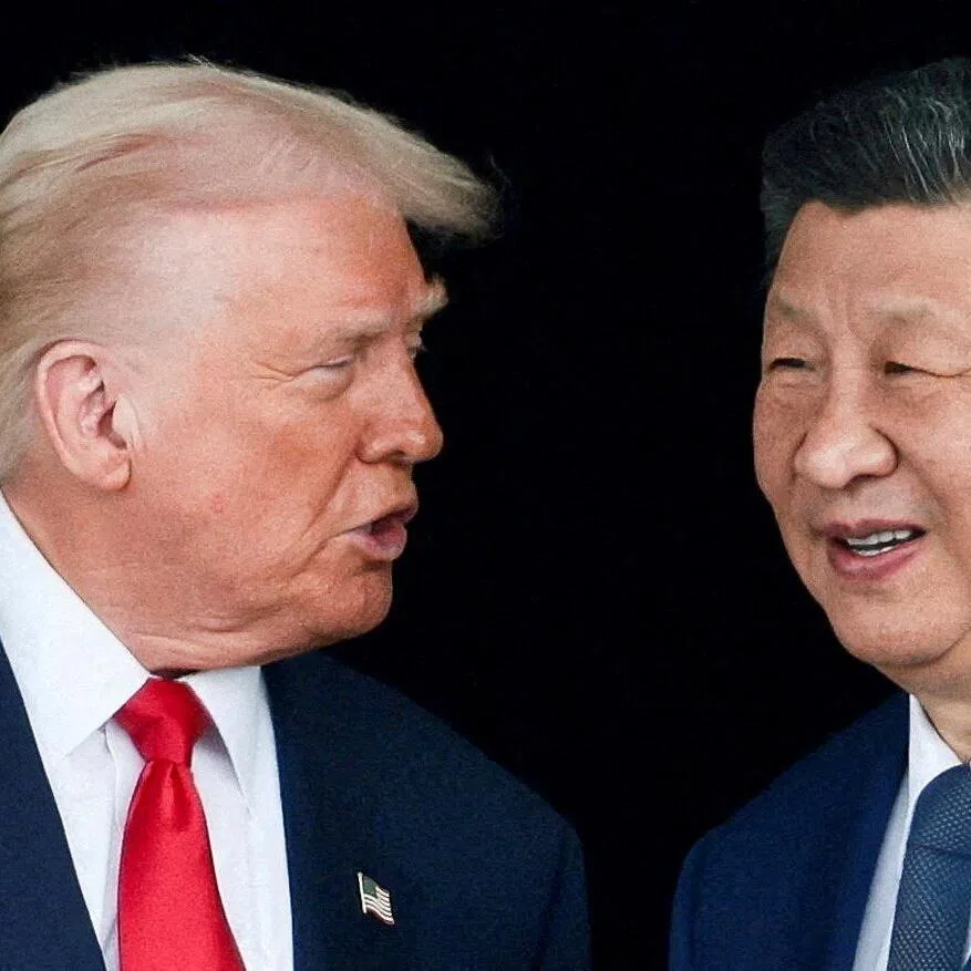 FILE PHOTO: U.S. President Donald Trump and Chinese President Xi Jinping talk as they leave after a bilateral meeting at Gimhae International Airport, on the sidelines of the Asia-Pacific Economic Cooperation (APEC) summit, in Busan, South Korea, October 30, 2025. REUTERS/Evelyn Hockstein/File Photo