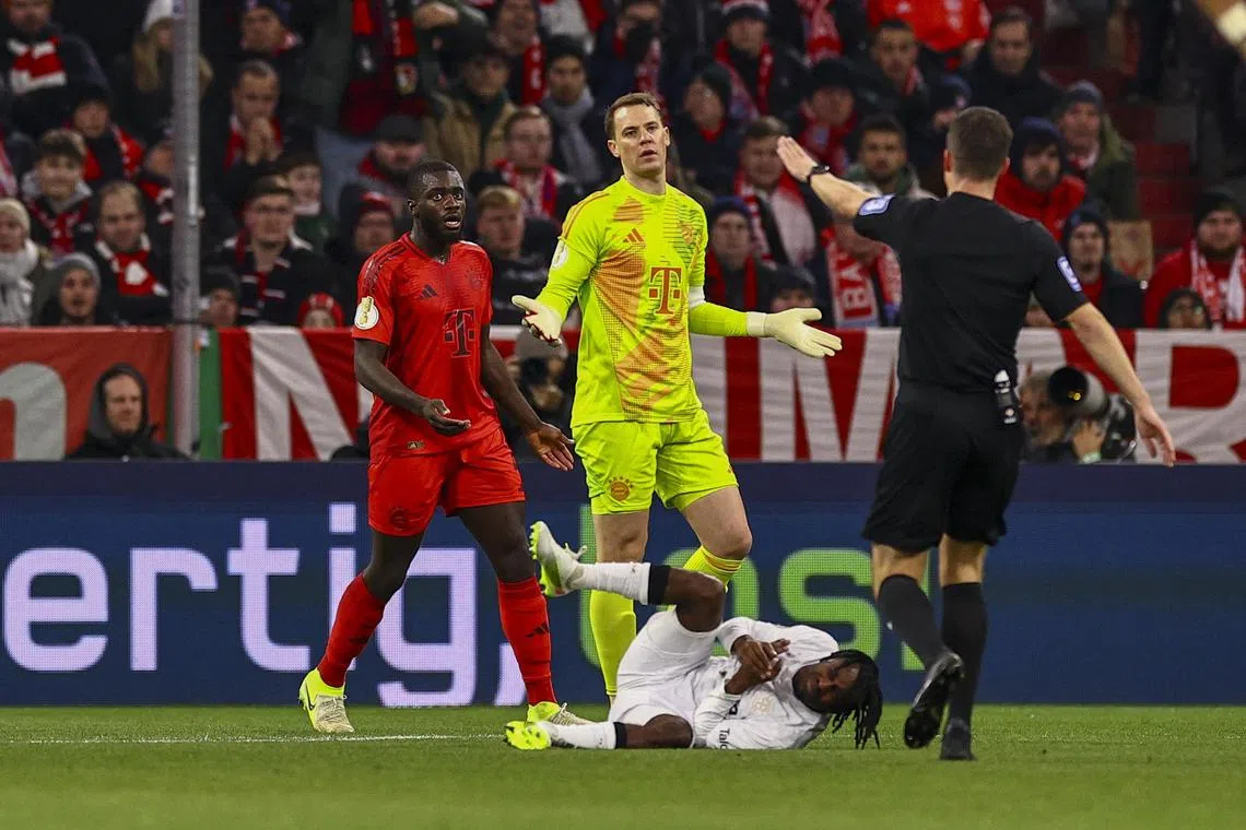 Bayern Munich goalkeeper Manuel Neuer receives a red during the German Cup match against Bayer Leverkusen.