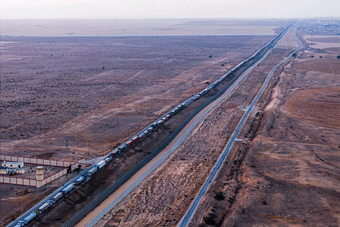 FILE PHOTO: A drone picture of a line of trucks waiting on an Egyptian road along the border with Israel, near the Rafah border crossing with the Gaza Strip May 2, 2024. REUTERS/Oren Alon/File Photo